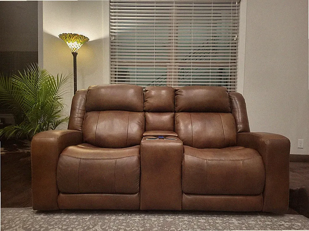 Top Grain leather loveseat with power recliner in NEW CONDITION. Caramel color.